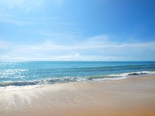 Beach And Sea. Beautiful Blue Sky With Clouds, Azure Sea With Waves, Yellow Sand. Panorama, Horizon, Seascape. View From The Shore To The Open Ocean. Sparkling Light On The Water, Sunny Day