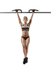 Wall Mural - young fitness woman chin-up on horizontal bar