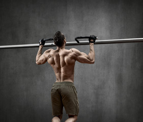 Wall Mural - man - bodybuilder perform exercise chin-up