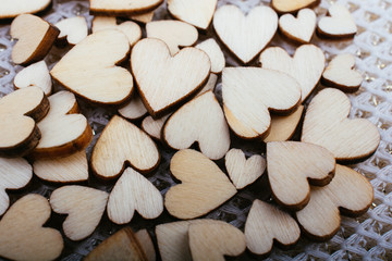 Wall Mural - Wooden hearts form round shape on white background