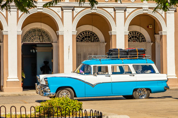 Old blue and white retro car in the center of cuban city Cienfuegos, Cuba