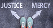 Justice and mercy as different choices in life - pictured as words Justice, mercy on a road to symbolize making decision and picking either Justice or mercy as an option, 3d illustration