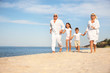 © New Africa - Cute little children with grandparents spending time together on sea beach
