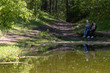 © olgalisa88 - A family sits on a log by the pond