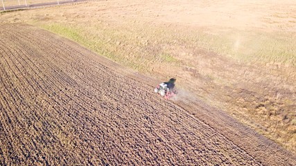 Farmer plowing his field. It plows and aerates the soil with a tractor.