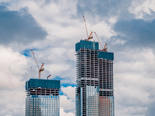 Construction work site and high rise building. High-rise building under construction. Reinforced concrete frame