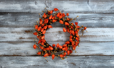 Poster - Seasonal autumn wreath with orange small flowers on white vintage wood background