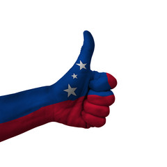 Hand making thumbs up sign, samoa painted with flag as symbol of thumbs up, like, okay, positive  - isolated on white background