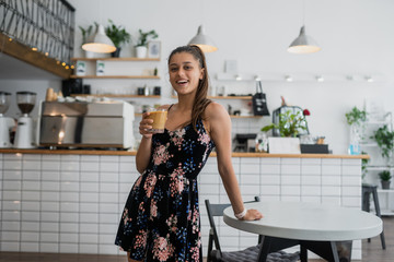 portrait of beautiful young woman going to drink coffee