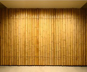 Wall Mural - background and texture of decorative yellow bamboo wood on finishing wall surface.