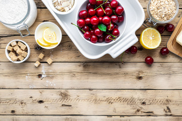 Poster - Raw ingredients for cooking cherry pie on wooden table top view