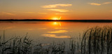 Fototapeta Sawanna - Picturesque sunset over the lake