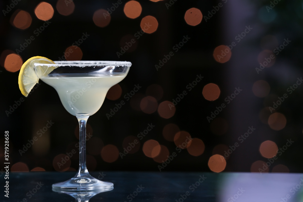 Glass of fresh martini on dark background