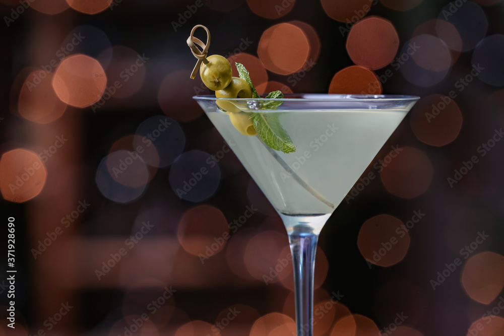 Glass of fresh martini on dark background