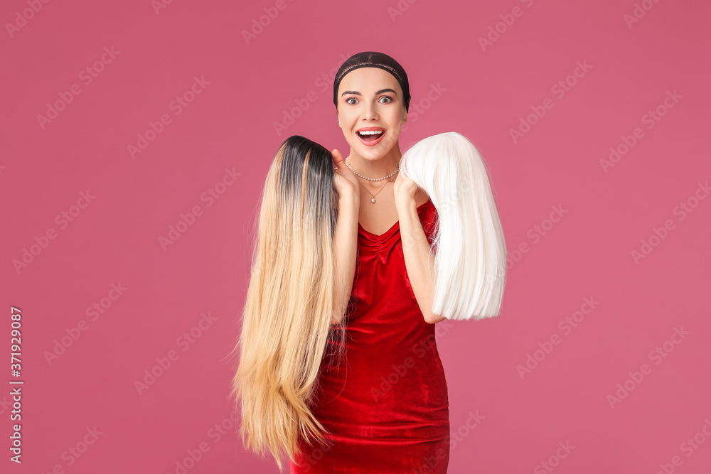 Beautiful young woman with different wigs on color background