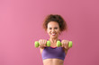© Pixel-Shot - Young woman doing aerobics on color background