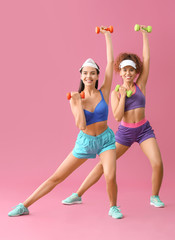 Wall Mural - Young women doing aerobics on color background