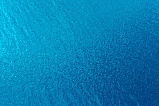 aerial view of a crystal clear sea water texture. view from above natural blue background. blue wate