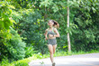 © Morakot - Beautiful Asian girls fitness runner running on a trail On roads and running in parks or nature trails
