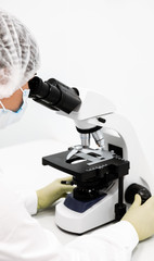 Doctor woman with microscope in laboratory. Scientific research