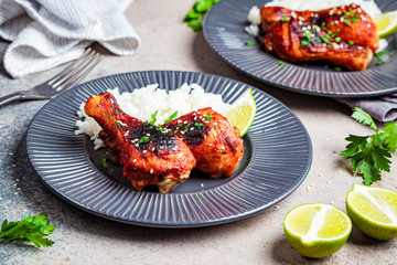 Wall Mural - Spicy chicken legs in teriyaki sauce or barbecue sauce with rice in gray plate.