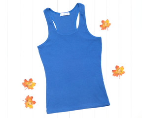 Wall Mural - Blue tank top and bright autumn leaves on a white background