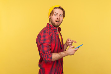 Wall Mural - wow! amazed guy in hipster beanie hat and shirt looking at camera with big eyes surprised expression