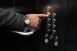 © Roman - cropped photo of young businessman pushing elevator button