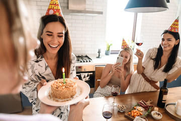 Wall Mural - Happy young cheerful girls celebrating birthday at home