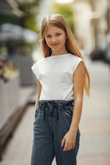 beautiful girl in a white t-shirt. child in a spring city.