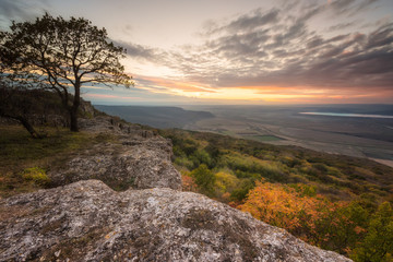 Wall Mural - amazing view from a hill with an autumn forest at sunset