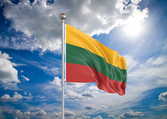 Realistic flag. 3D illustration. Colored waving flag of Lithuania on sunny blue sky background.