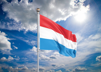 Realistic flag. 3D illustration. Colored waving flag of Luxembourg on sunny blue sky background.