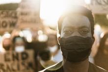 Young Black Man Wearing Face Mask During Equal Rights Protest - Concept Of Demonstrators On Road For No Racism Campaign- Focus On Eyes