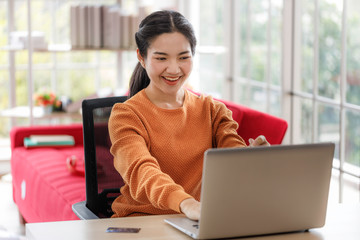 Young Asian women are using laptops to study online, work from home, and transact online during the coronavirus outbreak.