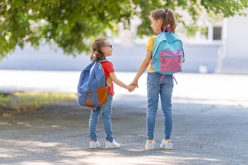 Wall Mural - Girls with backpack are going to school