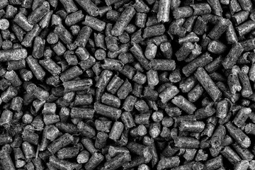 White and black wood pellets texture background. natural pile of wood pellets. organic biofuels. Alternative biofuel from sawdust.
 pile of compressed wood pellets