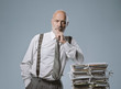 © stokkete - Confident businessman posing with a pile of paperwork