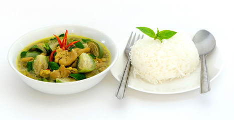 Green curry with chicken, eggplant, basil, red chillies, green chilies, coconut milk. Delicious Thai food that is good for your health. Eat white rice cooked in a white plate and put on a white ground