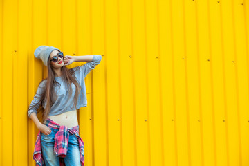 Wall Mural - Beautiful Trendy teen Girl over Yellow Wall