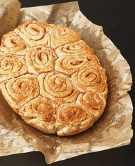 Sweet and tasty cinnamon pastry on baking paper