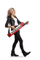 Wall Mural - Full length portrait of a woman smiling and playing a keytar synthesizer