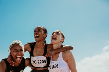 group of female runners enjoying victory