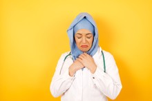 Face Of Sad Young Arab Doctor Woman Wearing Medical Uniform Crying Desperate And Depressed With Tears On Her Eyes Suffering Pain And Depression In Sadness Facial Expression And Emotion Concept