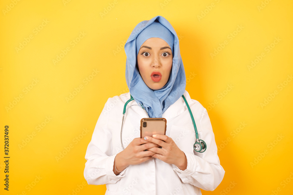 Photo of beautiful shocked beautiful muslim doctor woman wearing