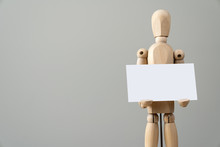Wooden Figure Mannequin Holding Blank Name Card In Hand