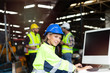 © Stella - Young beautiful woman industrial engineer worker wearing safely helmet and protective clothing using desktop computer at manufacturing industry plant factory