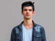 © Яна Солодкая - Isolated shot of young handsome male with trendy hair, has serious expression as listens to interlocutor, poses in studio against gray background
