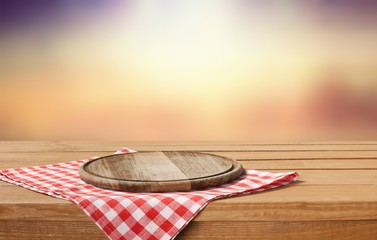 Poster - Wooden cutting board and tablecloth on wooden table