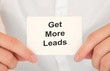 © Sinfebeth - Man's hands take a card with words Get more leads, finance and business concept.